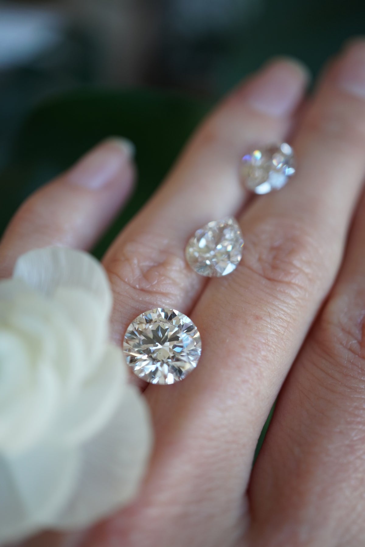 The back of a woman's hand with three diamonds on it.