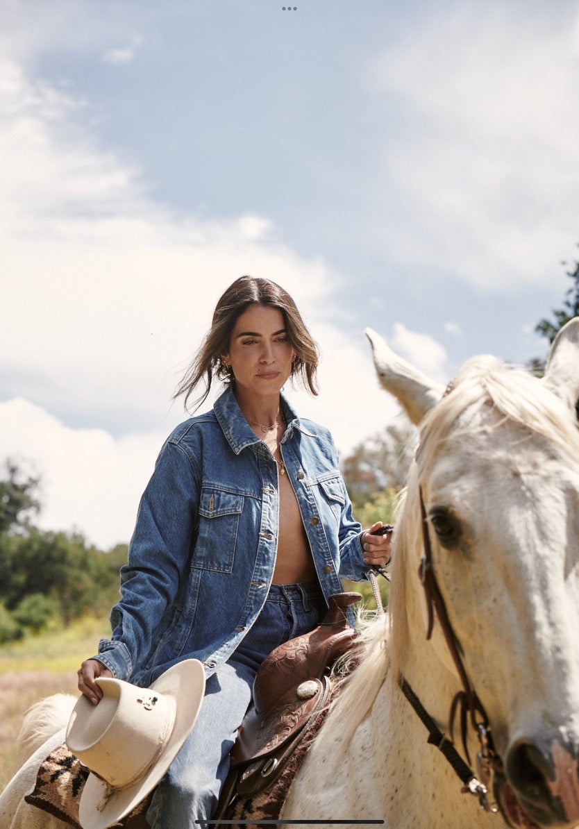 Nikki in denim, riding a white horse